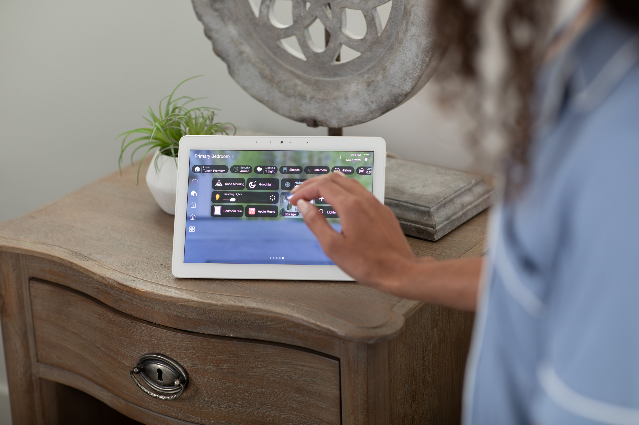 Control4 Touch panel in a able with a traditional home in the background